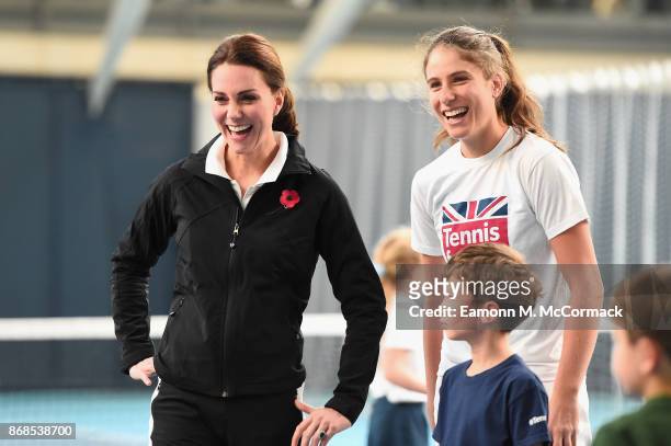 Catherine, Duchess of Cambridge and tennis player Johanna Konta play tennis with children as they visit the Lawn Tennis Association at National...