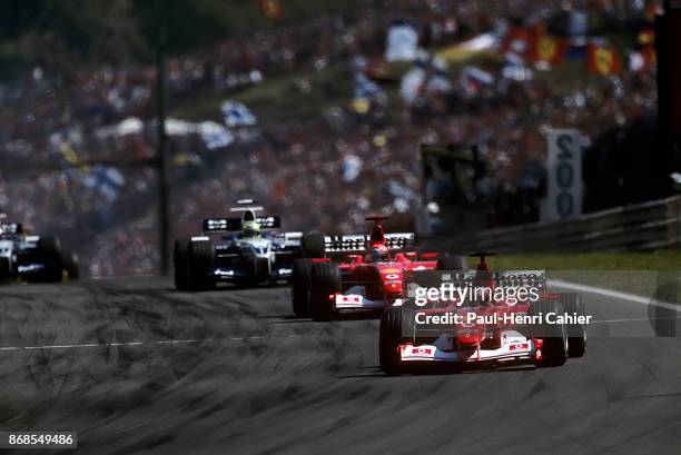 Rubens Barrichello, Michael Schumacher, Ralf Schumacher, Ferrari F2002, Williams-BMW FW24, Grand Prix of Hungary, Hungaroring, 18 August 2002. Rubens...