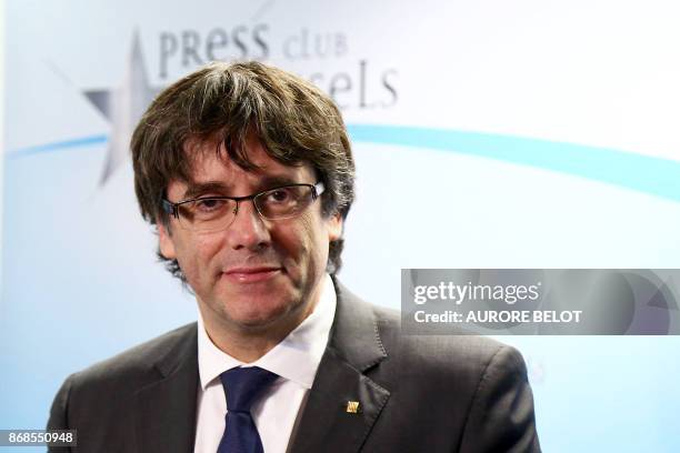 Catalonia's dismissed leader Carles Puigdemont along with other members of his dismissed government arrives to address a press conference at The...