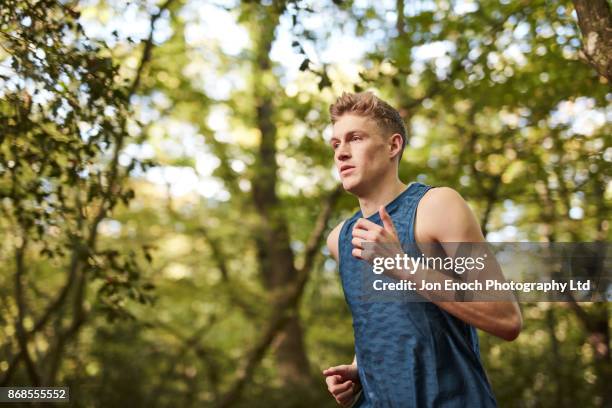 man running in woods - jon enoch stock-fotos und bilder