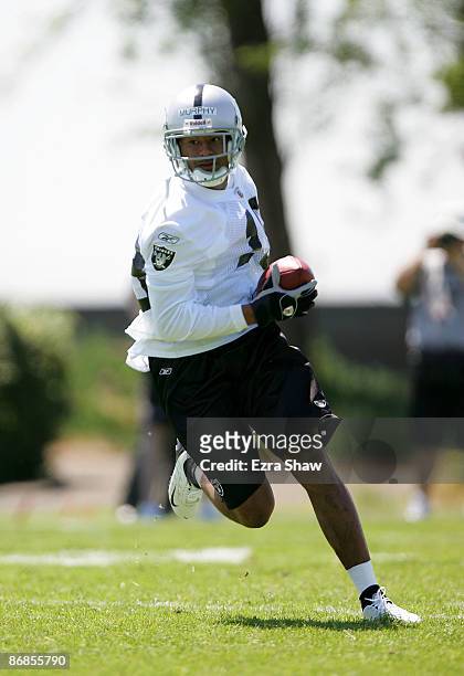 Louis Murphy of the Oakland Raiders runs with the ball during the Raiders minicamp at the team's permanent training facility on May 8, 2009 in...
