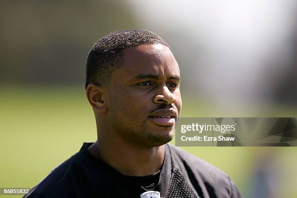 Nnamdi Asomugha of the Oakland Raiders watches practice from the sideline during the Raiders minicamp at the team's permanent training facility on...