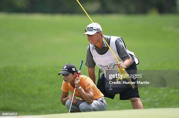 Lorena Ochoa of Mexico and her caddie Adam Woodward line up her birdie putt on the 11th hole during the second round of the Michelob Ultra Open at...