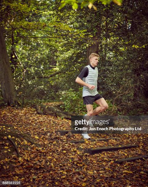 man running in woods - jon enoch stock pictures, royalty-free photos & images