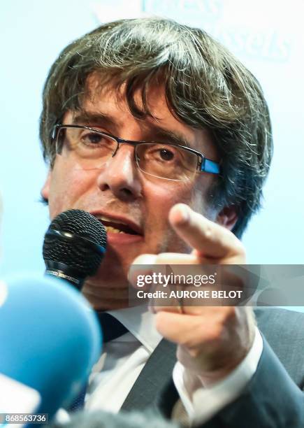 Catalonia's dismissed leader Carles Puigdemont, along with other members of his dismissed government address a press conference at The Press Club in...