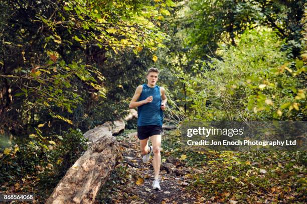 man running in woods - jon enoch stock-fotos und bilder