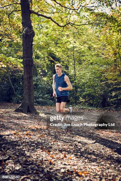 man running in woods - jon enoch stock-fotos und bilder