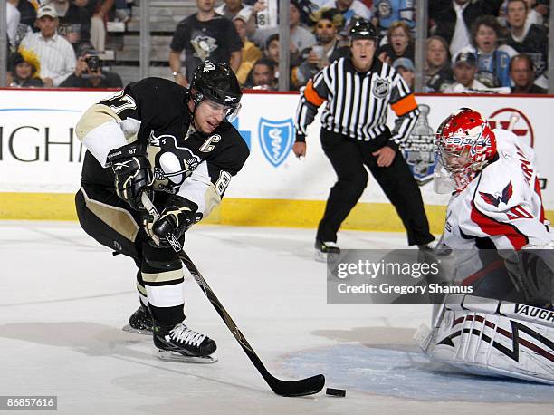 Sidney Crosby of the Pittsburgh Penguins maneuvers the puck in front of Simeon Varlamov of the Washington Capitals during Game Four of the Eastern...