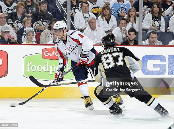 Alex Ovechkin of the Washington Capitals moves the puck in front of Sidney Crosby of the Pittsburgh Penguins during Game Four of the Eastern...