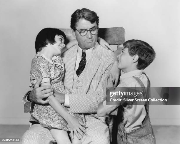 From left, American actors Mary Badham , Gregory Peck , and Phillip Alford in a scene from 'To Kill a Mockingbird' , 1962.
