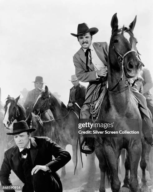 American actors Burt Lancaster and Audie Murphy , and horses, in a scene from 'The Unforgiven' , Durango, Mexico, 1960.