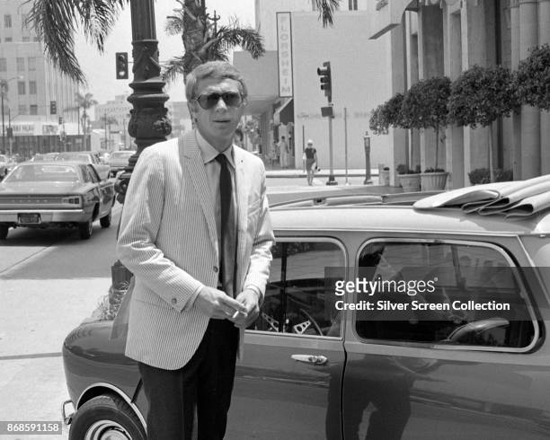 Portrait of American actor Steve McQueen as he stands on Wilshire Boulevard, Los Angeles, California, 1960s.