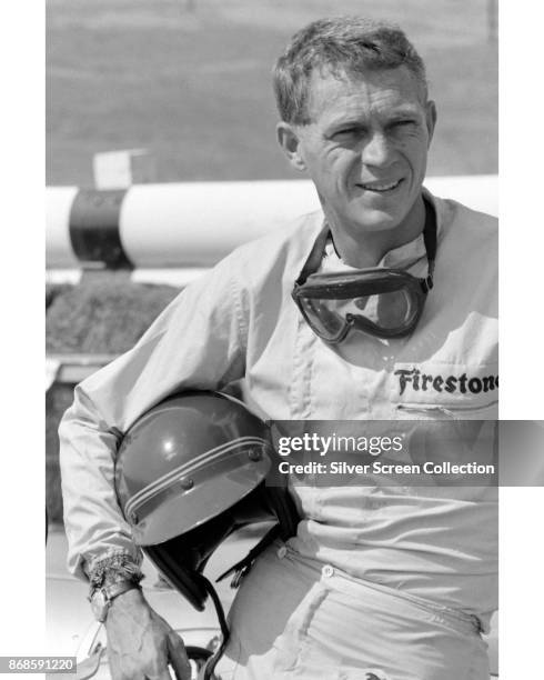 View of American actor Steve McQueen , in Firestone racing suit, at Riverside Raceway, Riverside, California, July 1966.