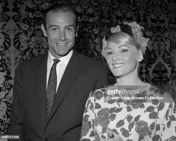 Married actors Sean Connery and Diane Cilento smile as they pose at the 21st Golden Globe Awards ceremony, Los Angeles, California, March 11, 1964....