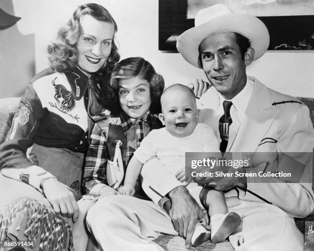 Family portrait of married American country musicians Audrey Williams and Hank Williams Sr as they pose with their children Lycrecia and Hank...