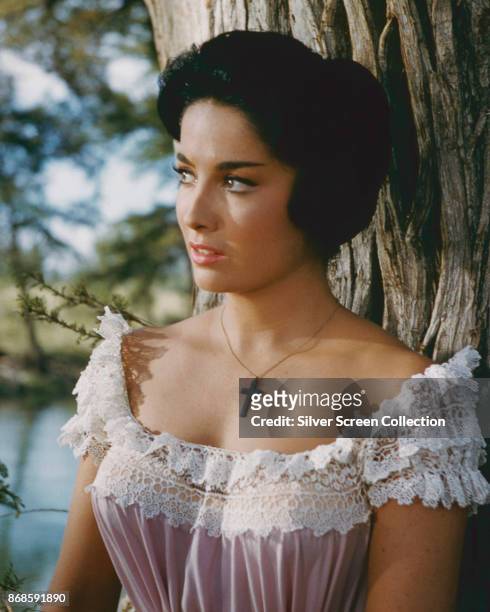 Argentine-American actress Linda Cristal leans against a tree in a scene from the film 'The Alamo' , 1960.