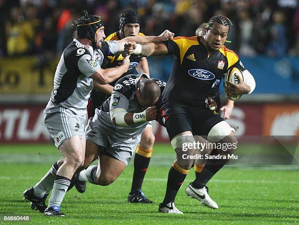 Sione Lauaki of the Chiefs fends off Andrew Hore of the Hurricanes during the round 13 Super 14 match between the Chiefs and the Hurricanes at...