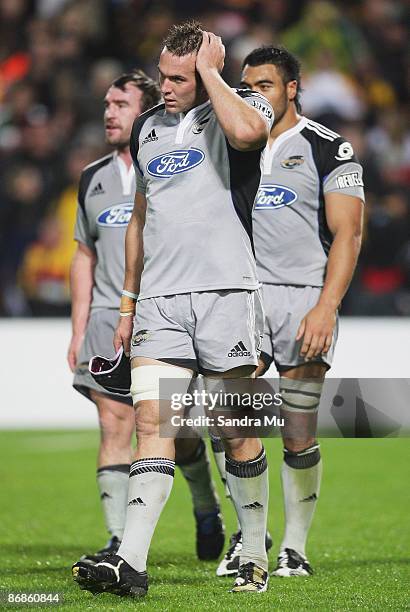 Andrew Hore , Bryn Evans and Victor Vito of the Hurricanes walk from the field after losing the round 13 Super 14 match between the Chiefs and the...