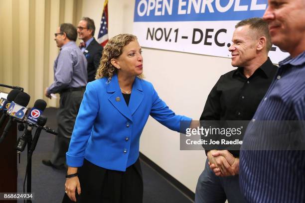 Rep. Debbie Wasserman Schultz greets Johnathan Goldberg and Michael Landers during a press conference at the Broward Regional Health Planning Council...