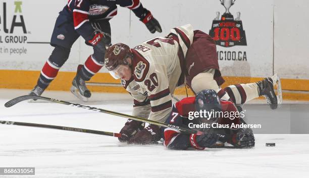 Kyle Bollers of the Saginaw Spirit gets flattened by Declan Chisholm of the Peterborough Petes in an OHL game at the Peterborough Memorial Centre on...