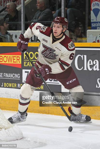 Austin Osmanski of the Peterborough Petes handles the puck against the Saginaw Spirit in an OHL game at the Peterborough Memorial Centre on October...