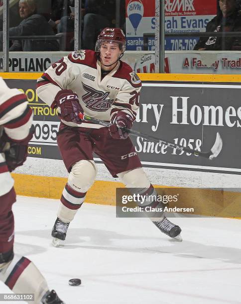 Declan Chisholm of the Peterborough Petes passes the puck against the Saginaw Spirit in an OHL game at the Peterborough Memorial Centre on October...