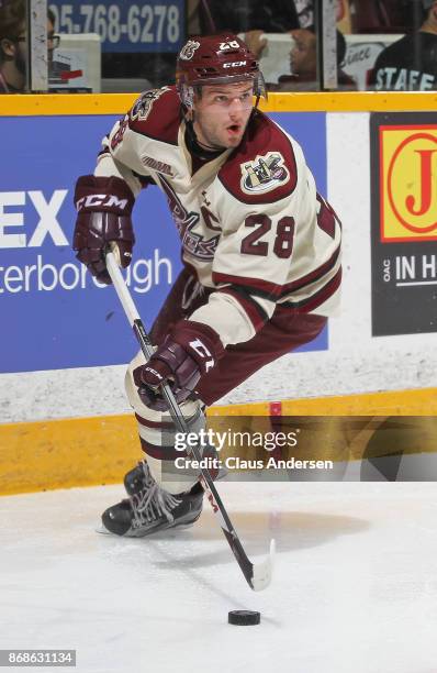 Logan DeNoble of the Peterborough Petes skates with the puck against the Saginaw Spirit in an OHL game at the Peterborough Memorial Centre on October...