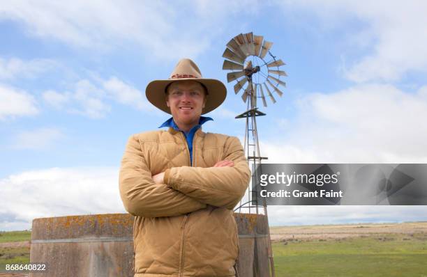 young sheep farmer out on land. - farmer australia ストックフォトと画像
