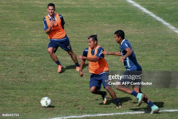 Honduran footballer Mario Martinez vies for the ball with Sergio Pena during a training session at Carlos Miranda stadium in Comayagua 80km north of...
