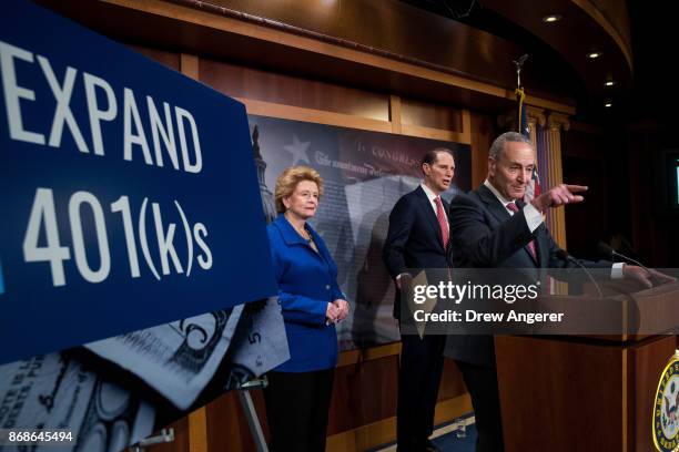 Sen. Debbie Stabenow and Sen. Ron Wyden look on as Senate Minority Leader Chuck Schumer speaks during a press conference to discuss their proposals...