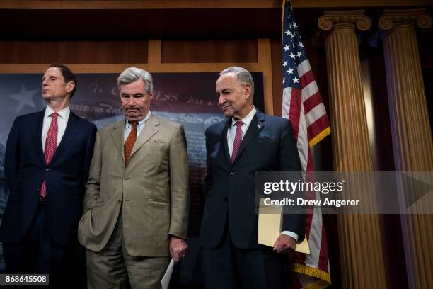 Sen. Ron Wyden , Senate Minority Leader Chuck Schumer and Sen. Sheldon Whitehouse attend a press conference to discuss their proposals for raising...