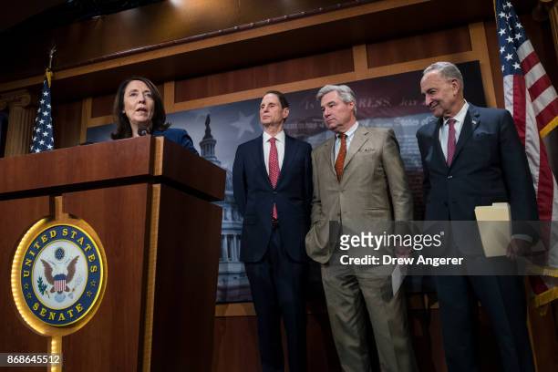 Sen. Maria Cantwell speaks as Sen. Ron Wyden , Senate Minority Leader Chuck Schumer and Sen. Sheldon Whitehouse look on during a press conference to...