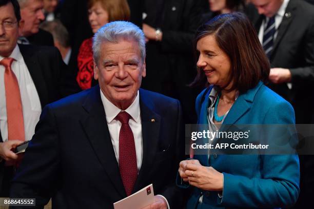 Former German President Joachim Gauck chats with Katrin Goering-Eckardt, parliamentary group co-leader of the Greens, before an official ceremony on...