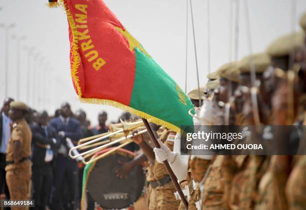 Burkinabe soldiers attend on October 31, 2017 in Ouagadougou a ceremony for the 3rd anniversary of the popular uprising that ousted Burkinabe...