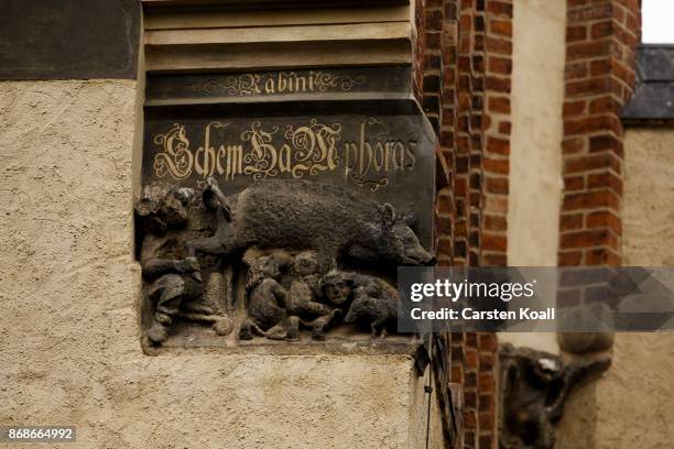 Sculpted relief shows the controversial 'Judensau,' or 'Jew's Sow' that shows Jews suckling from the teets of a pig on the facade of the 13th-century...