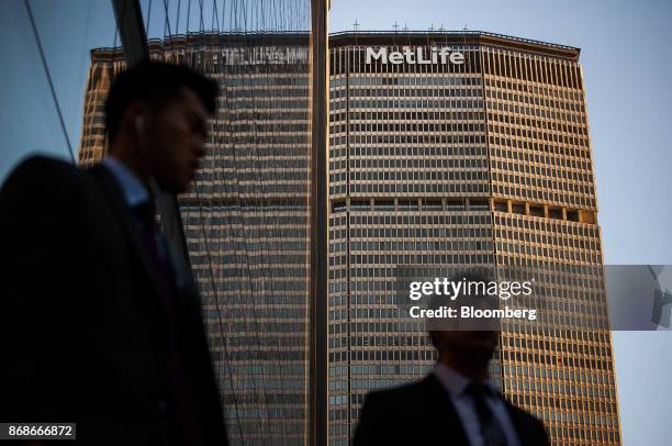 Pedestrians walk in front of the MetLife Building in New York, U.S., on Tuesday, Oct. 31, 2017. MetLife Inc. Is scheduled to release earnings figures...