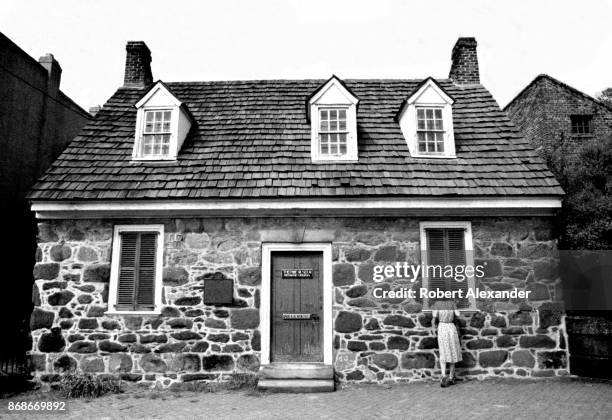 Visitor to Richmond, Virginia, peeks in the window of the Edgar Allan Poe Museum in 1984. Opened in 1922, the museum houses a collection of Poe...