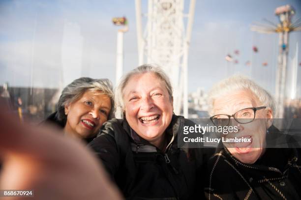 active senior girlfriends at the fair in amsterdam - woman selfie stockfoto's en -beelden