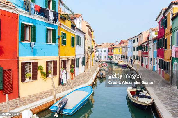 bright vibrant houses along the canal in burano, veneto region, italy - burano photos et images de collection