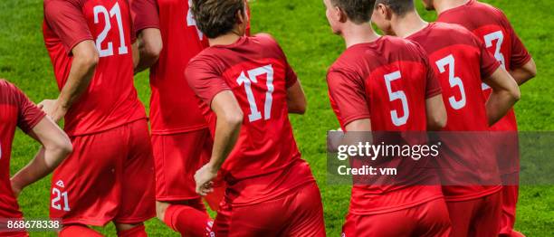 red soccer team - football strip stock pictures, royalty-free photos & images