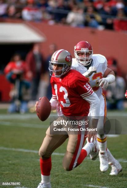 Steve Bono of the San Francisco 49ers scrambles with the ball against the Kansa City Chiefs during an NFL football game December 14, 1991 at...