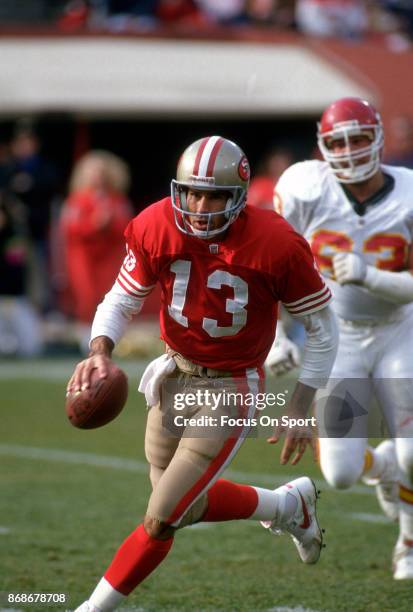 Steve Bono of the San Francisco 49ers scrambles with the ball against the Kansa City Chiefs during an NFL football game December 14, 1991 at...