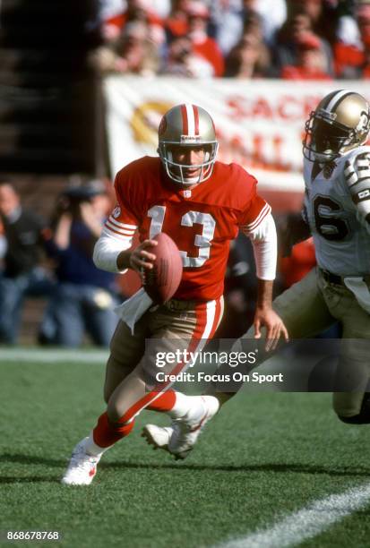 Steve Bono of the San Francisco 49ers runs with the ball against the New Orleans Saints during an NFL football game December 1, 1991 at Candlestick...