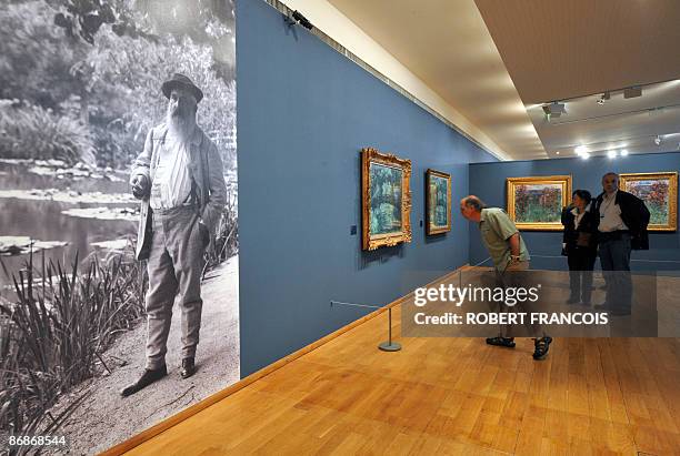 Visitors look at paintings as they visit on May 2009 at the Impressionnists new Museum in Giverny, West of Paris, Normandy, an exhibition dedicated...