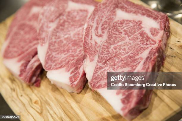wagyu beef steaks sit on a table - beef marbling stock pictures, royalty-free photos & images