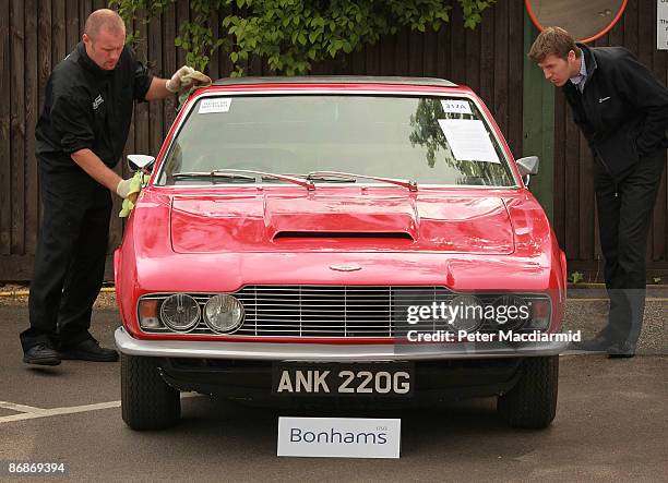 Worker cleans a 1969 Aston Martin DBS Vantage Saloon at the Aston Martin Works Service factory during an auction held by Bonham's on May 9, 2009 in...