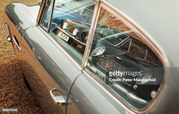 Line of of Aston Martin cars is reflected in another at the Aston Martin Works Service factory during an auction held by Bonham's on May 9, 2009 in...