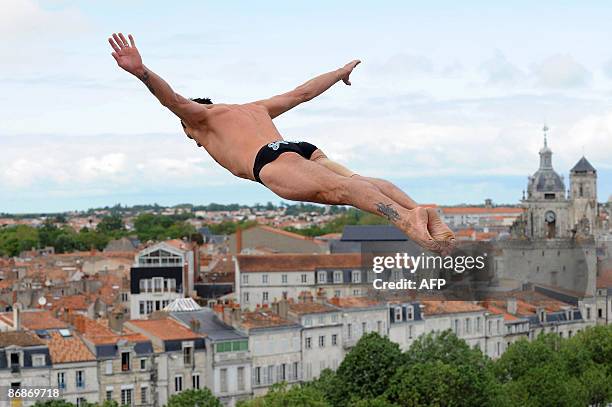 Russian Artem Silchenko launches off the 27.5 metre high platform during the Red Bull Cliff Diving World Series in La Rochelle, on May 8, 2009. Round...