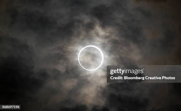 the sun is obscured by the moon during an annular solar eclipse - annular solar eclipse stock pictures, royalty-free photos & images