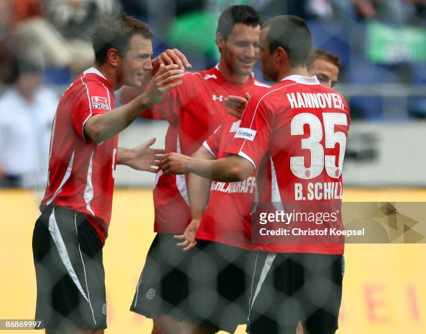 Arnold Bruggink of Hannover celebrates his first goal with Mario Eggimann, Jan Schlaudraff and Bastian Schulz of Hannover during the Bundesliga match...